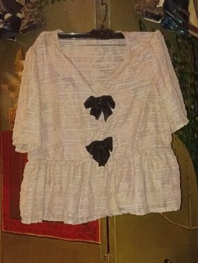 Light Cream Textured Peplum Top with Black Bow Accents